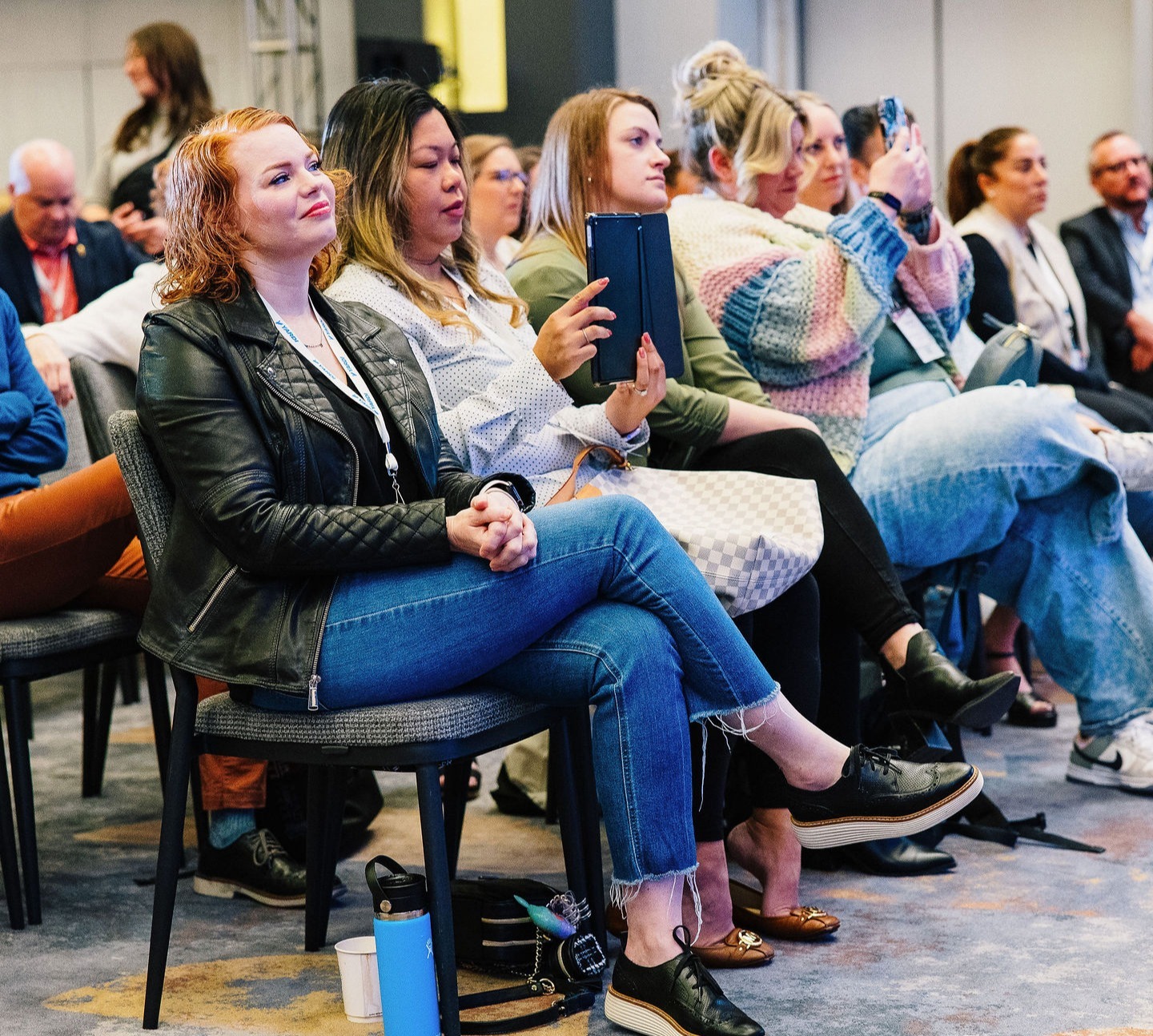People sitting in chairs watching session at PropertyCon